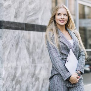 stylish-businesswoman-with-clipboard-city
